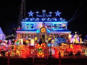In this 2011 photo visitors look at the lights at 226 Roseville Terrace in Fairfield, Conn. (Christian Abraham/Hearst Connecticut Media via AP)