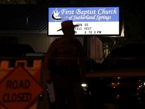 A law enforcement official stands watch outside the First Baptist Church of Sutherland Springs, the scene of a deadly shooting, Sunday, Nov. 5, 2017, in Sutherland Springs, Texas.