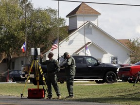 Law enforcement officials continue to investigate the scene of a shooting at the First Baptist Church of Sutherland Springs, Tuesday, Nov. 7, 2017, in Sutherland Springs, Texas.