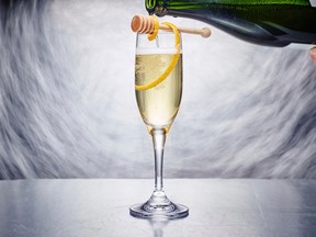 This Nov. 20, 2017 photo provided by The Culinary Institute of America shows a Kindness sparkling wine cocktail in Hyde Park, N.Y. It's a mix of botanical gin, lightly spiced Drambuie and the complex sweetness of honey, all topped off with the requisite New Year’s Eve bubbles. (Phil Mansfield/The Culinary Institute of America via AP)