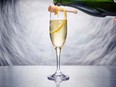 This Nov. 20, 2017 photo provided by The Culinary Institute of America shows a Kindness sparkling wine cocktail in Hyde Park, N.Y. It's a mix of botanical gin, lightly spiced Drambuie and the complex sweetness of honey, all topped off with the requisite New Year’s Eve bubbles. (Phil Mansfield/The Culinary Institute of America via AP)