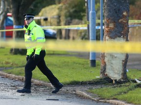 Police attend the scene where a stolen car crashed into a tree Saturday and killed several pedestrians in Leeds, England, Sunday Nov. 26, 2017.