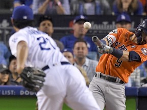 Houston Astros' Marwin Gonzalez hits a double off Los Angeles Dodgers starting pitcher Yu Darvish, of Japan, during the second inning of Game 7 of the World Series Wednesda in Los Angeles. (AP Photo/Mark J. Terrill)