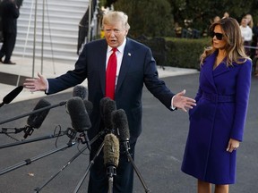 First lady Melania Trump looks on as President Donald Trump speaks with reporters before departing the White House for a trip to Asia, in Washington, on Friday, Nov. 3, 2017. (Evan Vucci/AP Photo)