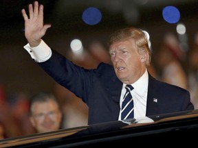 U.S. President Donald Trump waves as he arrives at the Noi Bai International Airport in Hanoi, Vietnam, on Saturday, Nov. 11, 2017. (Minh Hoang/AP Photo)