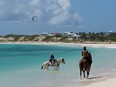 Take a horseback ride in the sea at one of the many beautiful beaches on Anguilla.  JIM BYERS PHOTO