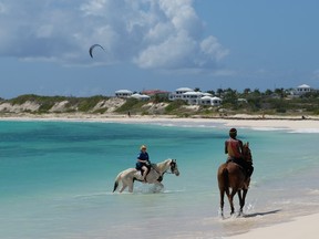 Take a horseback ride in the sea at one of the many beautiful beaches on Anguilla.  JIM BYERS PHOTO
