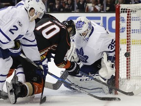 Maple Leafs goalie Curtis McElhinney (right) stops a shot by Ducks' Corey Perry during NHL action in Anaheim, Calif., last season. The Leafs take on the Ducks tonight. (Jae C. Hong/AP Photo/Files)
