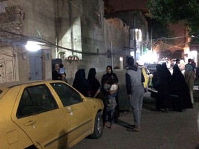 People stand in the street after feeling aftershocks from an earthquake in Baghdad, Iraq, on Sunday, Nov. 12, 2017. The deadly earthquake hit the region along the border between Iran and Iraq on Sunday. (Hadi Mizban/AP Photo)