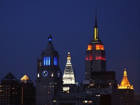 The Empire State Building in New York lit up at night.
