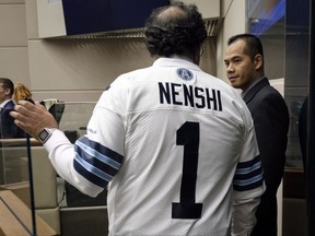 Calgary mayor Naheed Nenshi wears a Toronto Argonauts during a council meeting at city hall in Calgary on Monday, Nov. 27, 2017. THE CANADIAN PRESS/Jeff McIntosh