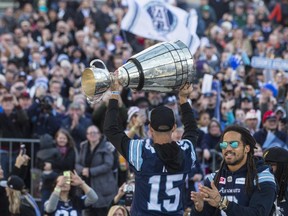 Toronto Argonauts' Ricky Ray holds the Grey Cup as fans gathered in Toronto's Nathan Phillips Square as the team holds a Cup winning rally, on Tuesday , November 28 2017. THE CANADIAN PRESS/Chris Young