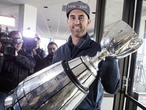Toronto Argonauts quarterback Ricky Ray holds the Grey Cup as speaks to members of the media as the teams returns to Toronto on Monday, November 27 2017.  THE CANADIAN PRESS/Chris Young