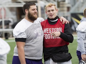 Western Mustangs quarterback Chris Merchant (right) talks with teammate Spencer Hood during practice ahead of their Vanier Cup game against the Laval Rouge et Or in Hamilton, Ont., Thursday, November 23, 2017. THE CANADIAN PRESS/Aaron Lynett