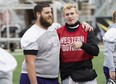 Western Mustangs quarterback Chris Merchant (right) talks with teammate Spencer Hood during practice ahead of their Vanier Cup game against the Laval Rouge et Or in Hamilton, Ont., Thursday, November 23, 2017. THE CANADIAN PRESS/Aaron Lynett