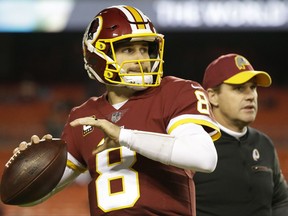 Washington Redskins quarterback Kirk Cousins (8) warms up as head coach Jay Gruden watches before an NFL football game against the New York Giants in Landover, Md., Thursday, Nov. 23, 2017. (AP Photo/Mark Tenally)