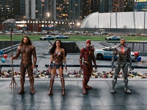 This image released by Warner Bros. Pictures shows Jason Momoa, from left, Gal Gadot, Ezra Miller and Ray Fisher in a scene from "Justice League." (Warner Bros. Entertainment Inc. via AP)