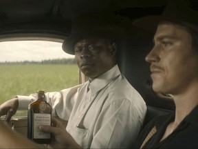 This image released by Netflix shows Jason Mitchell, left, and Garrett Hedlund in a scene from "Mudbound." (Netflix via AP)