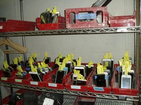 In this Aug. 31, 2017, photo provided by Lauren Carly, items are stored in the lost and found operations of the Burning Man festival in Black Rock City, Nev. The usual suspects top this year’s list of the most frequently lost items in the Nevada desert at the annual festival: 582 cellphones, 570 backpacks and 529 IDs. Still missing are a marching band hat with gold mirror tiles, a furry cheetah vest with orange lining, a headdress with horns and a chainmail loincloth skirt. (Lauren Carly via AP)