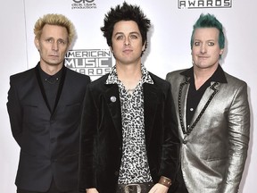In this Nov. 20, 2016 file photo, Mike Dirnt, from left, Billie Joe Armstrong, and Tre Cool, of Green Day, arrive at the American Music Awards in Los Angeles. (Photo by Jordan Strauss/Invision/AP)