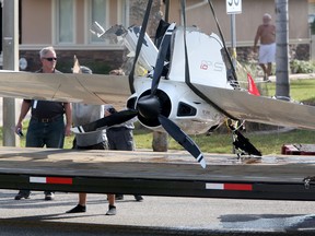 The remains of an ICON A5 ultralight airplane are moved from a boat ramp in the Gulf Harbors neighborhood of New Port Richey, Fla., on Nov. 8, 2017