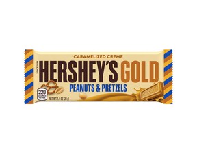 This image released by The Hershey Company shows their new candy bar Hershey's Gold that will go on sale Dec. 1, 2017. It’s described as a caramelized cream bar embedded with salty peanut and pretzel bits. (The Hershey Company via AP)