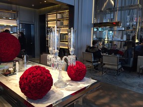 This Nov. 9, 2017 photo shows a candelabra and bouquets of red roses at the Baccarat Hotel in New York. Baccarat is a world-renowned manufacturer of fine French crystal and the hotel’s decor is a sumptuous showcase for crystal chandeliers, stemware and more. It’s got one of the most luxurious looks of any hotel in the city. (AP Photo/Beth J. Harpaz)