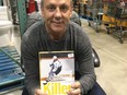 Doug Gilmour holds a copy of his newly released book, Killer.