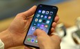 Customers setup an iPhone X at an Apple showroom in Sydney on November 3, 2017. 
Apple iPhone X went for sale in Australia with long queues outside the Apple stores. (SAEED KHAN/AFP/Getty Images)