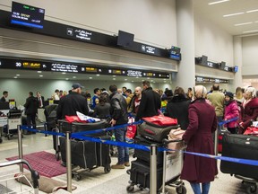 Syrian refugees check their baggage at Beirut International airport, as they prepare to depart Lebanon to resettle into Canada, in accordance with the Government of Canadaâs Operation PROVISION on December 10, 2015.