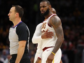 LeBron James held back by a teammate on Nov. 28, 2017 (GETTY)