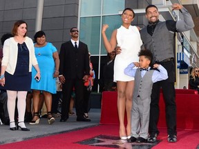 Jennifer Hudson poses with her husband David Daniel Otunga, Sr.; and her son David Daniel Otunga, Jr. at a ceremony honoring her with a Star along the Hollywood Walk of Fame in Hollywood, California on November 13, 2013. (FREDERIC J. BROWN/AFP/Getty Images)