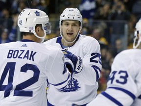 Maple Leafs winger James van Riemsdyk (centre) celebrates his goal with Tyler Bozak and Nazem Kadri during the first period in Boston on Saturday. (The Associated Press)