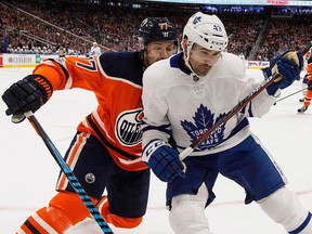 Toronto Maple Leafs' Nazem Kadri and Edmonton Oilers' Oscar Klefbom battle for the puck during first period NHL action in Edmonton, Alta., on Thursday Nov. 30, 2017. THE CANADIAN PRESS/Jason Franson