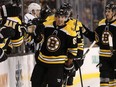 Boston Bruins' Brad Marchand is congratulated at the bench after scoring against the Los Angeles Kings during the first period of an NHL hockey game in Boston, Saturday, Oct. 28, 2017. (AP Photo/Winslow Townson)