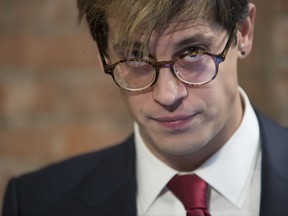 FILE - In this Feb. 21, 2017 file photo, Milo Yiannopoulos pauses while speaking during a news conference in New York. Yiannopoulos is appearing Tuesday, Oct. 31, at California State University, Fullerton, at the invitation of the school's College Republicans. Other student groups are planning what they call a "Unity Block Party." (AP Photo/Mary Altaffer, File)