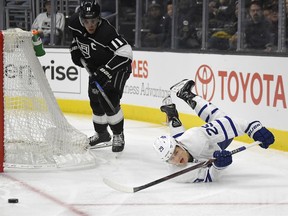 Toronto Maple Leafs center William Nylander, right, falls as he passes the puck while under pressure from Los Angeles Kings center Anze Kopitar, of Slovenia, during the first period of an NHL hockey game, Thursday, Nov. 2, 2017, in Los Angeles. (AP Photo/Mark J. Terrill)