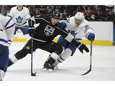 Los Angeles Kings left wing Adrian Kempe, left, of Sweden, vies for the puck with Toronto Maple Leafs defenseman Nikita Zaitsev, of Russia, during the second period of an NHL hockey game, Thursday, Nov. 2, 2017, in Los Angeles.