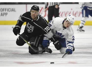 Los Angeles Kings left wing Tanner Pearson, left, and Toronto Maple Leafs right wing Kasperi Kapanen, of Finland, fall as they go after the puck during the third period of an NHL hockey game, Thursday, Nov. 2, 2017, in Los Angeles. The Kings won 5-3.