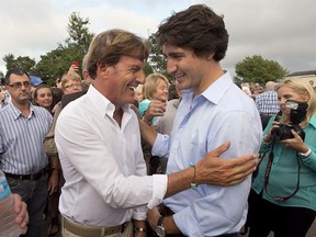 Liberal leader Justin Trudeau, right, chats with Stephen Bronfman, the party's chief fundraiser, at a barn party in St. Peters Bay, P.E.I. on Wednesday, Aug. 28, 2013.