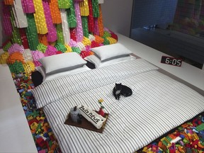 The adult's bedroom with cat and newspaper all made of Lego bricks inside the new Lego sleepover house teamed up with Airbnb, in Billund, Denmark, in this photo dated Sept. 8, 2017.  Those who want to join Lego's private sleepover must enter a competition and describe what they would build if they had an infinite supply of Lego bricks, then the winner will get the chance to create their entry under expert supervision, as part of their stay at the Lego House. (AP Photo/James Brooks)