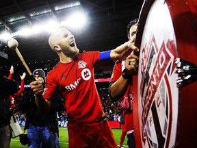 Toronto FC's Michael Bradley bangs on a drum after his team defeated the Philadelphia Union in MLS soccer playoff action in Toronto, Wednesday October 26, 2016. THE CANADIAN PRESS/Mark Blinch