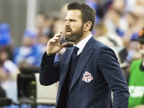 Toronto FC head coach Greg Vanney watches his team play the Montreal Impact during first half action in the first leg of the MLS Eastern Conference final at the Olympic Stadium Tuesday, November 22, 2016 in Montreal. THE CANADIAN PRESS/Paul Chiasson