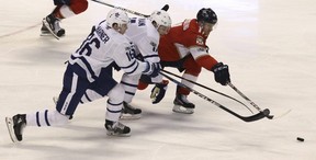 Florida Panthers’ Jonathan Huberdeau , right, reaches for the puck as Toronto Maple Leafs’ Zach Hyman, center, and Toronto Maple Leafs’ Mitchell Marner (16) defend during the second period of an NHL hockey game, Wednesday, Nov. 22, 2017, in Sunrise, Fla. (AP Photo/Luis M. Alvarez)