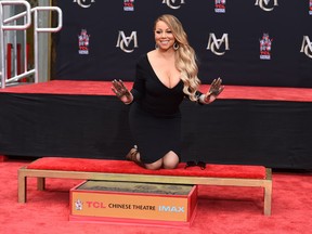 In this Wednesday, Nov. 1, 2017, file photo, Mariah Carey poses for photographers during her hand and footprint ceremony at the TCL Chinese Theatre in Los Angeles. Carey, the artist with the most No. 1 hits on the Billboard Hot 100 chart, is one of the nominees for the 2018 Songwriters Hall of Fame. (Photo by Jordan Strauss/Invision/AP, File)