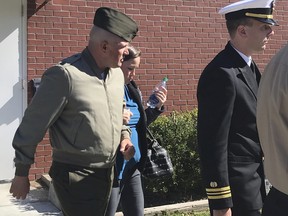 In this Tuesday, Oct., 31, 2017 photo, U.S. Marine Gunnery Sgt. Joseph A. Felix, his wife, and his lawyers exit a courtroom after testimony at Camp Lejeune, N.C.