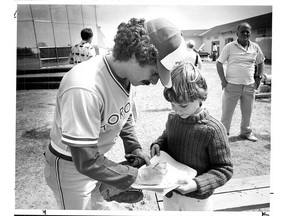 A young fan, Todd Newgren of Toronto, asks Bono for his autograph. (Michael Peake/Toronto Sun files)
