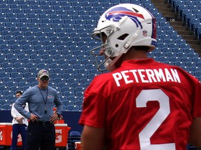 Buffalo Bills head coach Sean McDermott (background) eyes quarterback Nathan Peterman at the team’s rookie camp in Orchard Park, N.Y., in May. John Kryk/Postmedia Network)