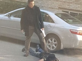 Property manager Michael McSorley is pictured taking down an alleged package theif in this photo posted on Facebook. (Michael McSorley/Facebook)