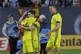 Columbus Crew's Hector Jimenez (16) embraces teammate teammate Wil Trapp (20) after losing to New York City FC in an MLS Eastern Conference semifinal soccer match Sunday, Nov. 5, 2017, in New York. New York City FC won 2-0, but the Crew advances to the conference championship with a 4-3 aggregate score. (AP Photo/Mark Lennihan)